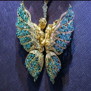 Elegant Gold and Blue Butterfly Necklace with embracing couple as body.